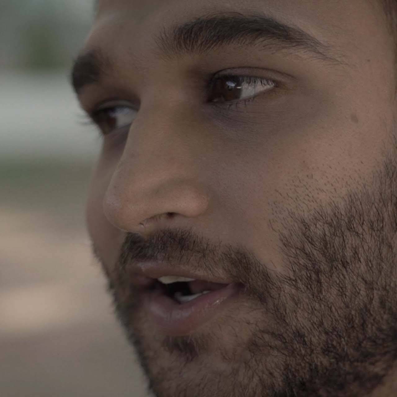 Extreme close up shot of a man talking intimately to camera