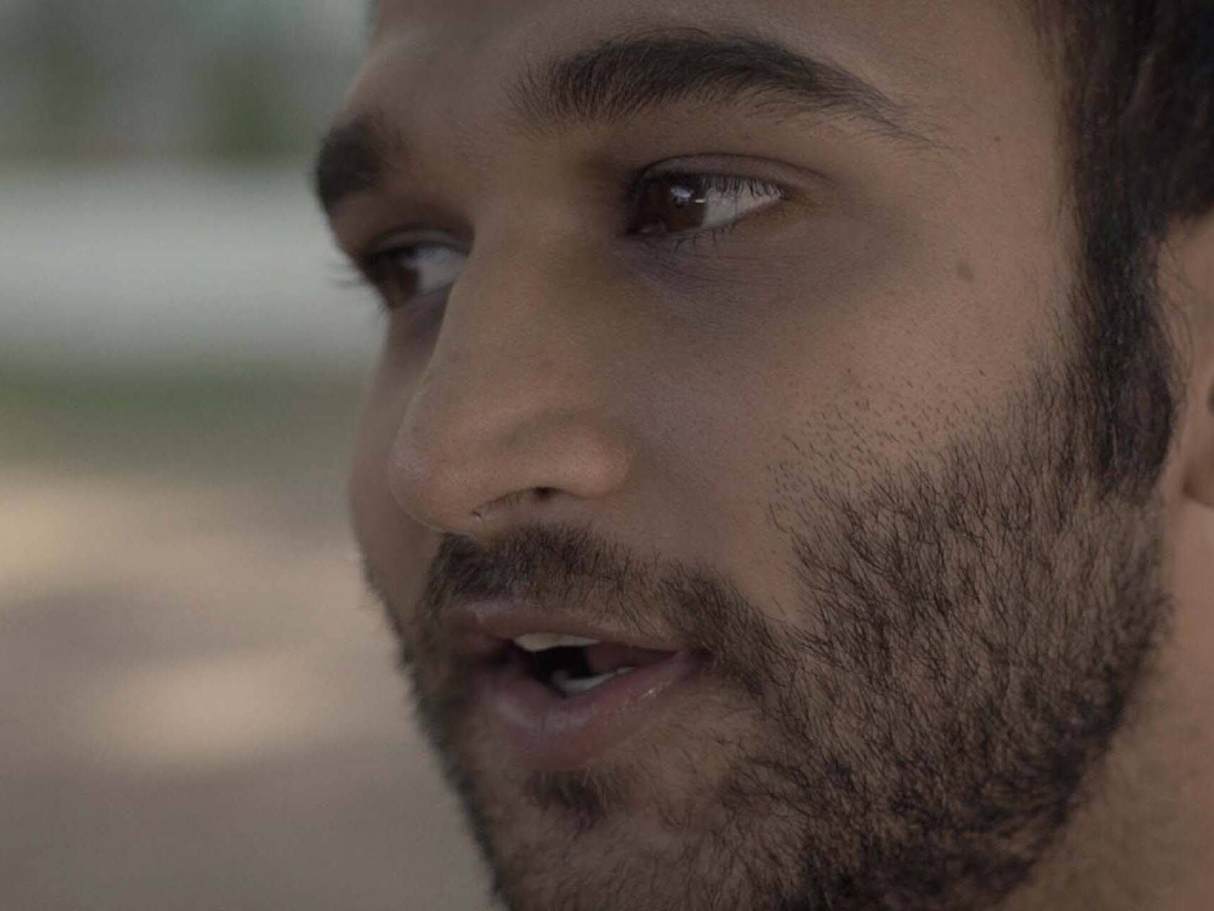 Extreme close up shot of a man talking intimately to camera