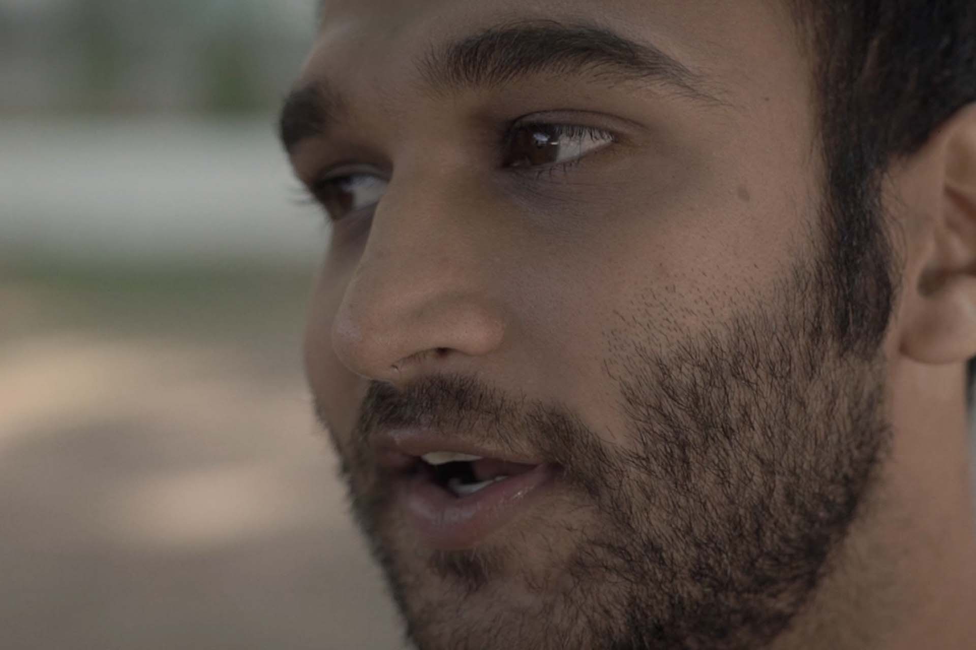 Extreme close up shot of a man talking intimately to camera