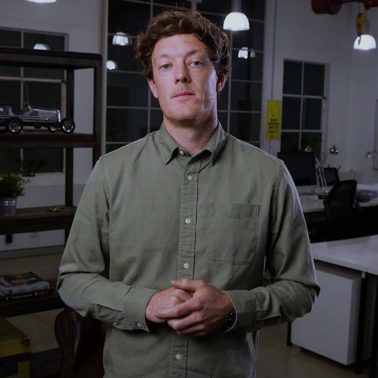 Man in office setting presenting to camera