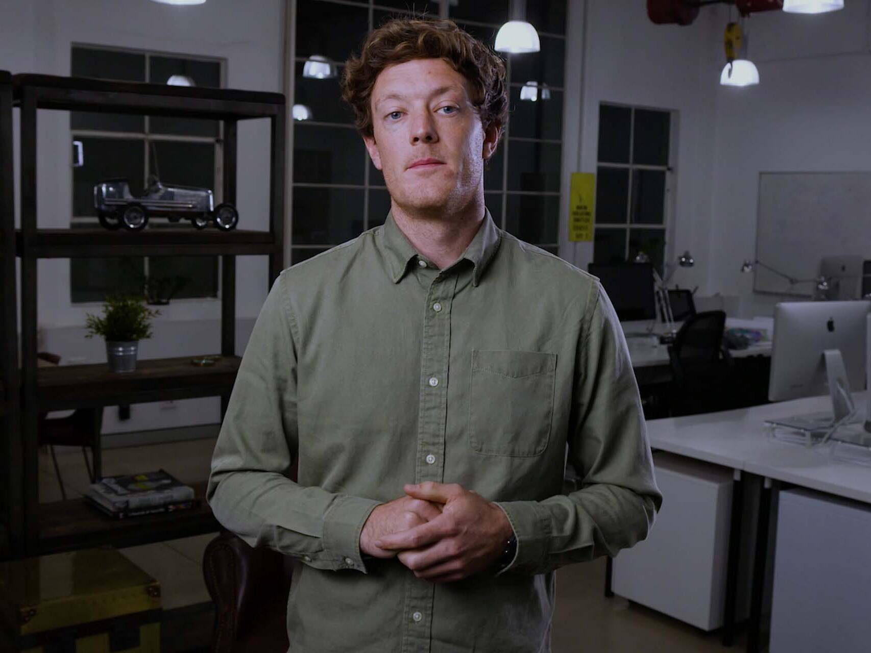 Man in office setting presenting to camera