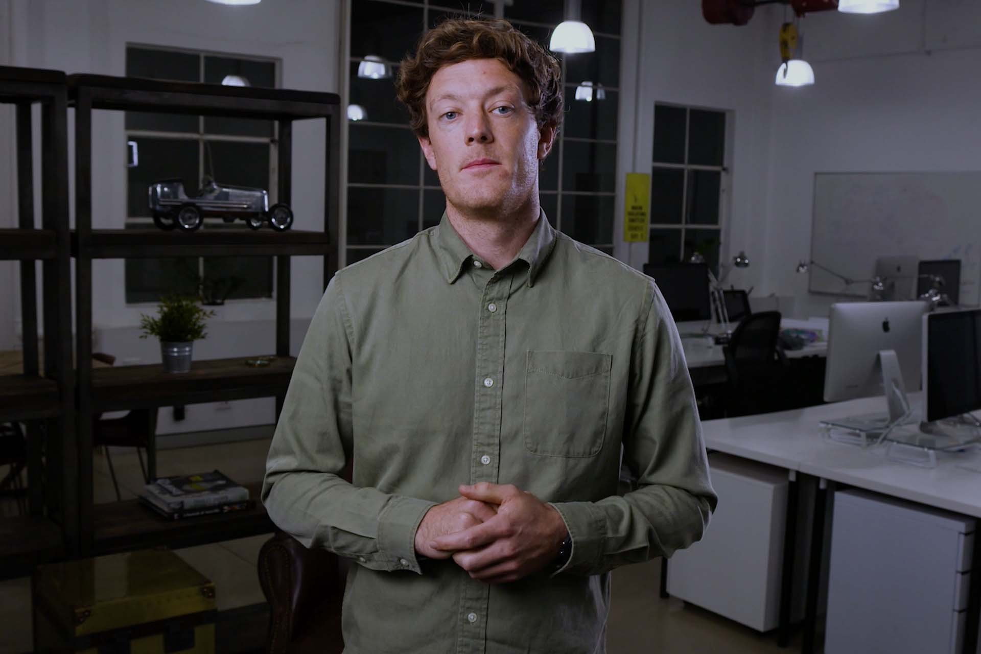 Man in office setting presenting to camera