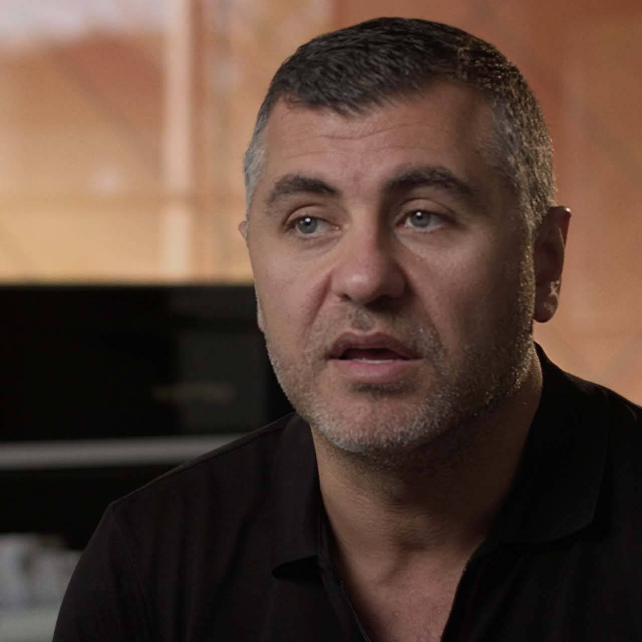 Close up of man in relaxed home environment talking to camera