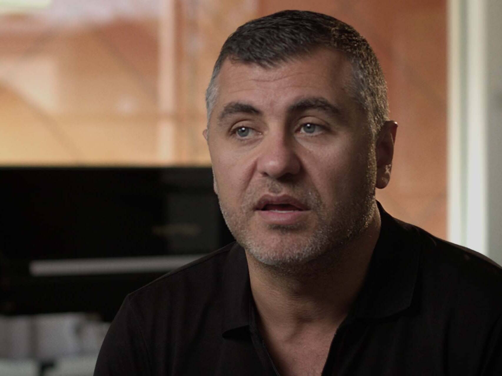 Close up of man in relaxed home environment talking to camera