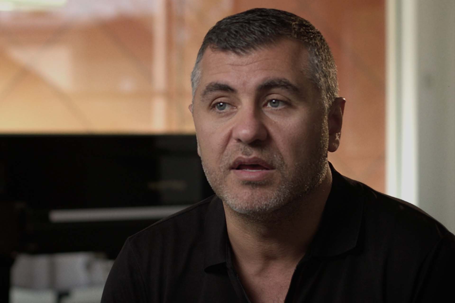 Close up of man in relaxed home environment talking to camera