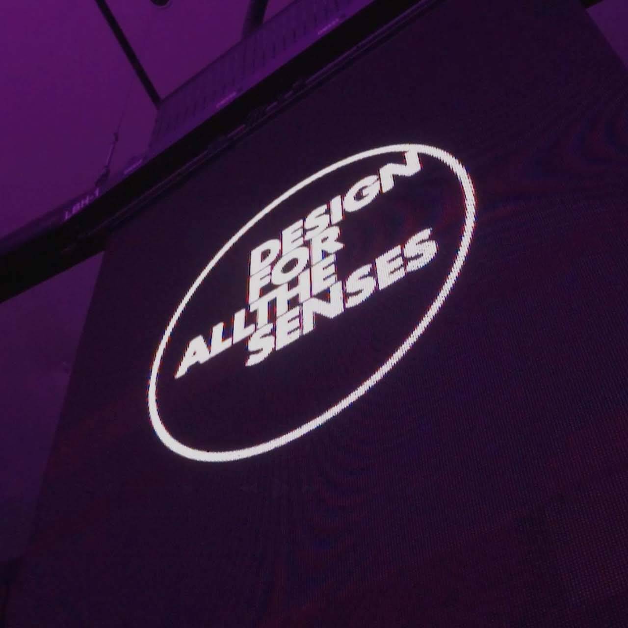 An event banner with the Design For All The Senses logo