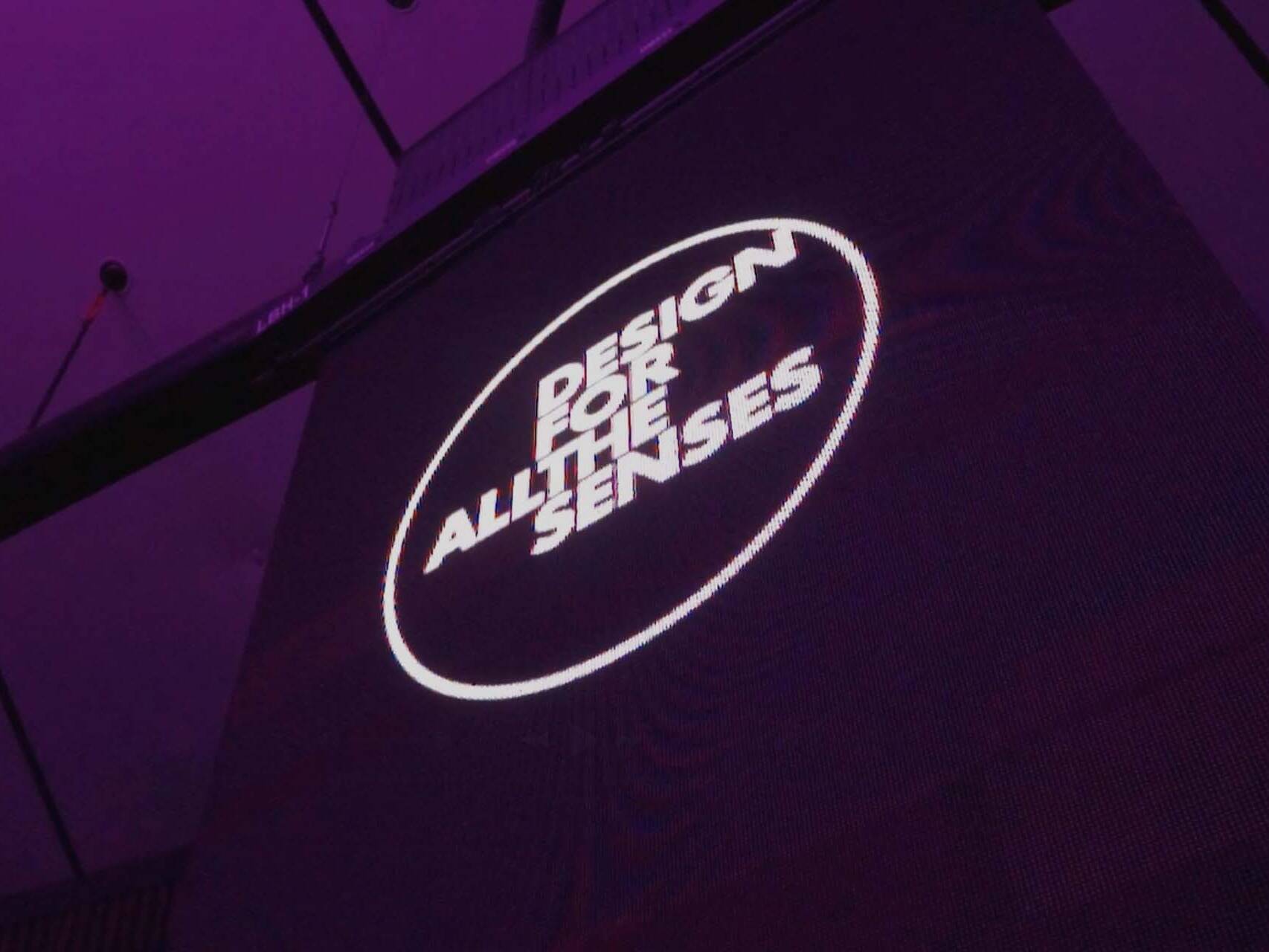 An event banner with the Design For All The Senses logo