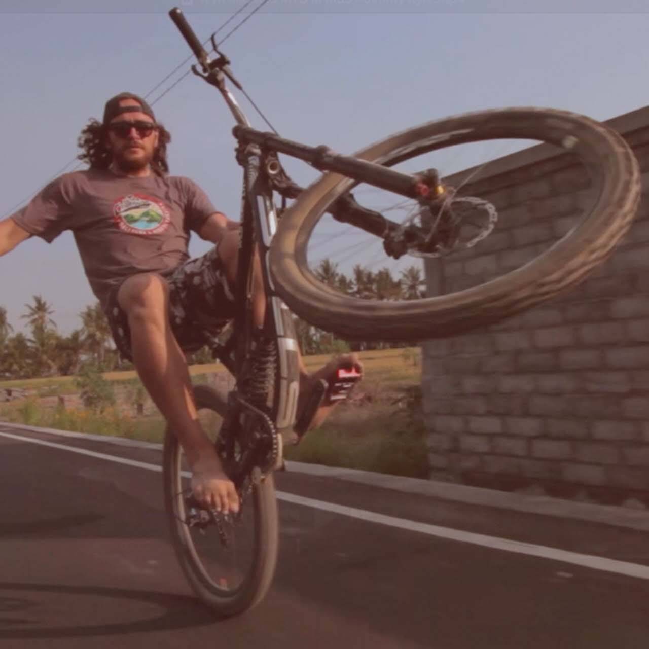Wyn Masters performing a wheelie on his bike